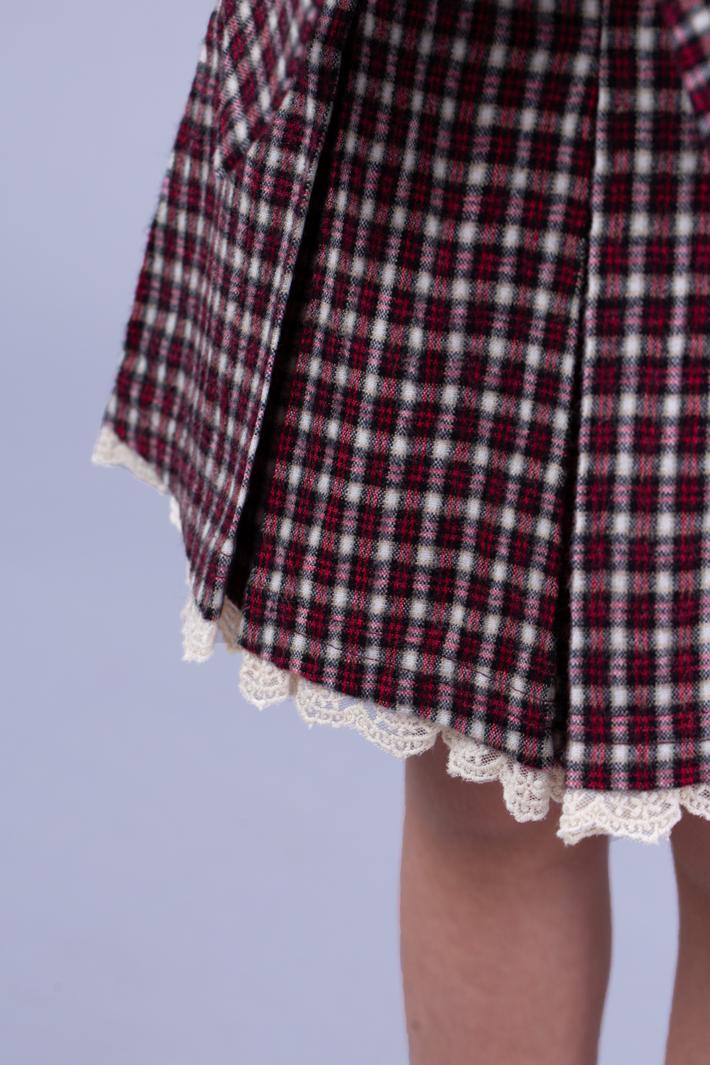 Maroon tie up top and small checkered skirt