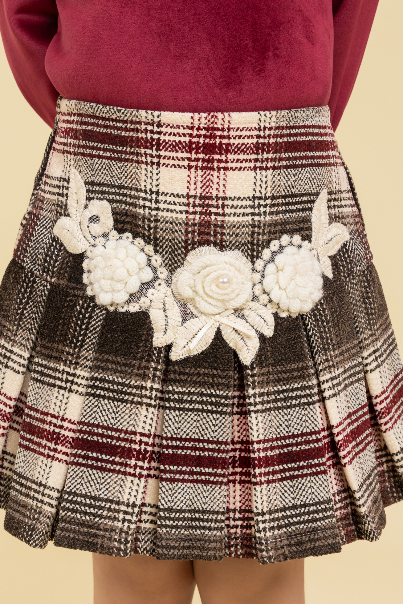 Maroon top and checkered skirt with fancy patch