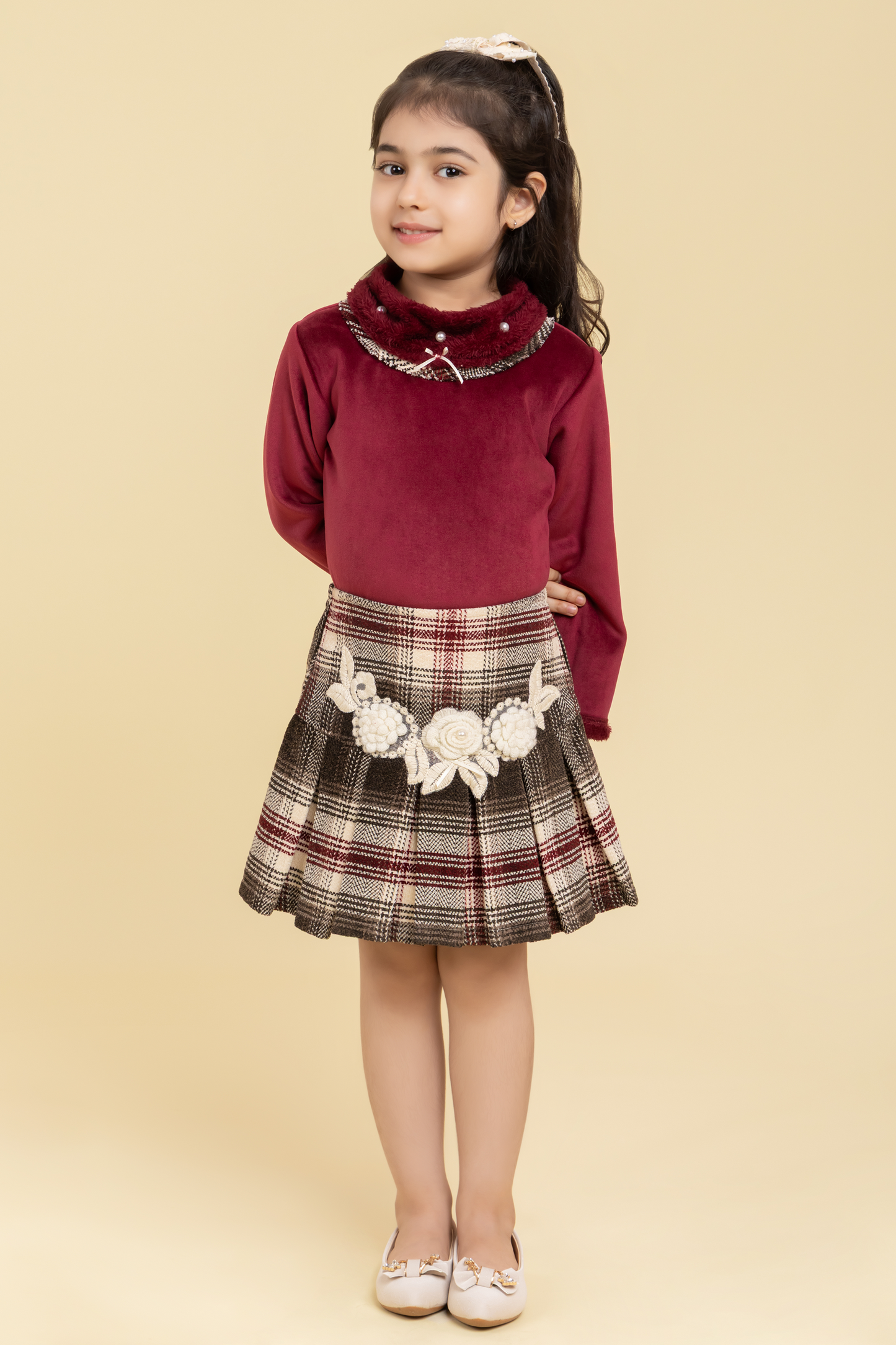 Maroon top and checkered skirt with fancy patch