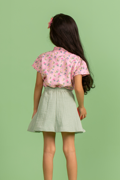 Pink printed top with tie up bow and green skirt