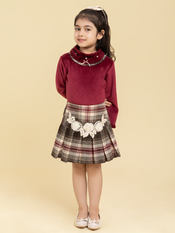 Maroon top and checkered skirt with fancy patch