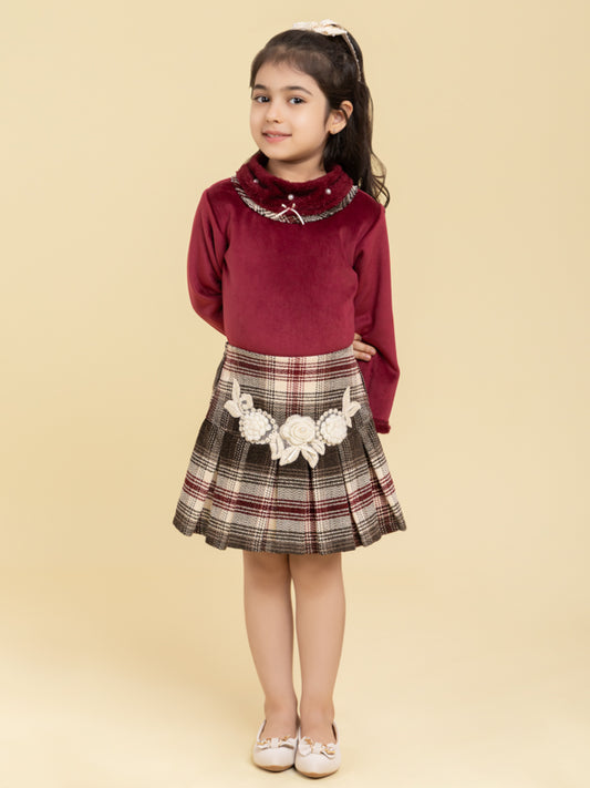 Maroon top and checkered skirt with fancy patch